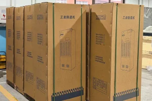 Warehouse staff receiving a shipment of large industrial dehumidifiers