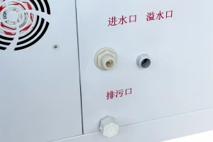 Detail view of an ultrasonic humidifier's water inlet, overflow, and drain ports.