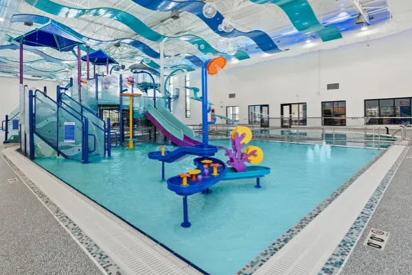 Indoor aquatic center environment protected by Swimming Pool Dehumidifier for moisture control