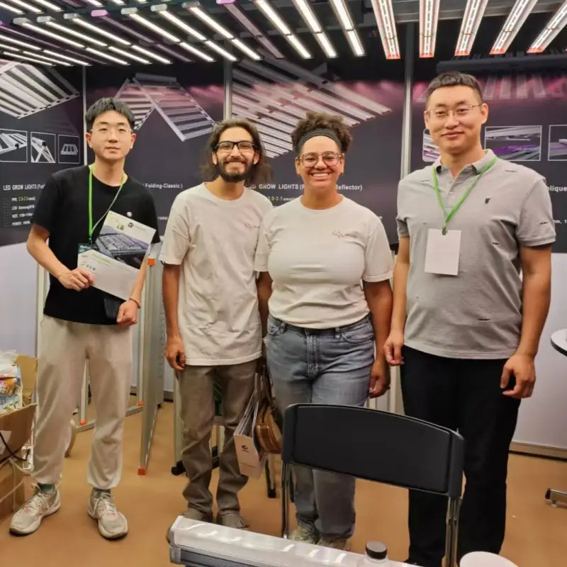 A diverse team stands together for a Ruiwang Group photo at a trade show.