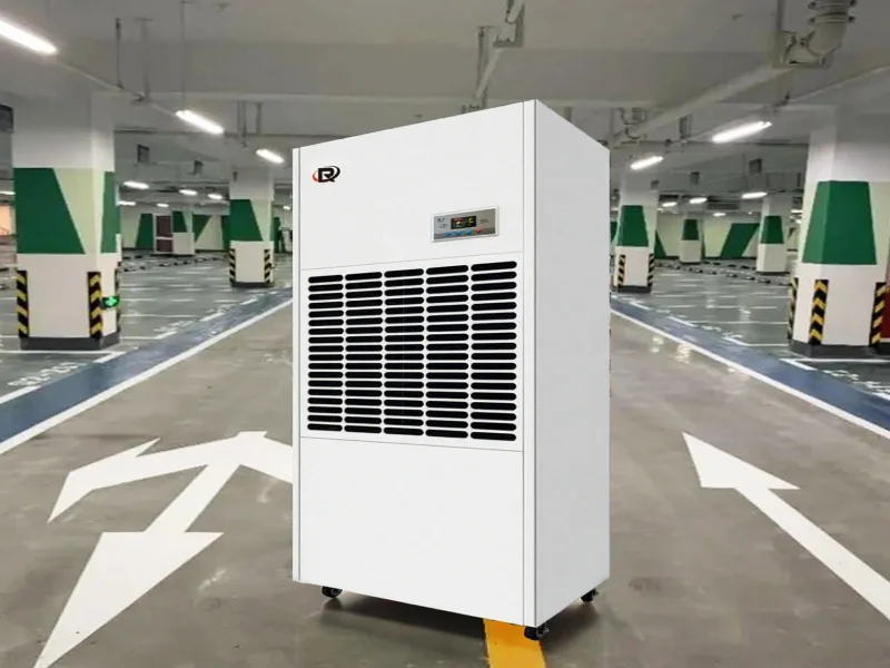 Industrial dehumidifier in a large basement parking garage.