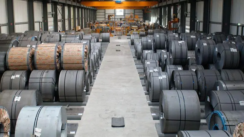 Metal coils stored in an industrial warehouse for humidity-controlled storage
