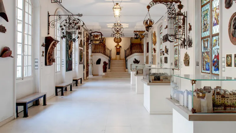 Museum gallery with display cases and artworks in a controlled indoor environment