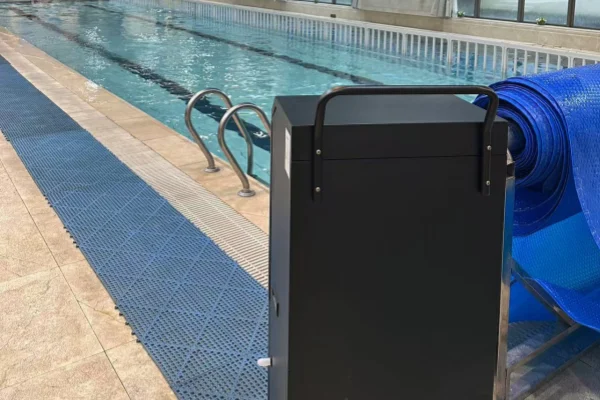Commercial dehumidifier for swimming pool in use next to an indoor swimming pool